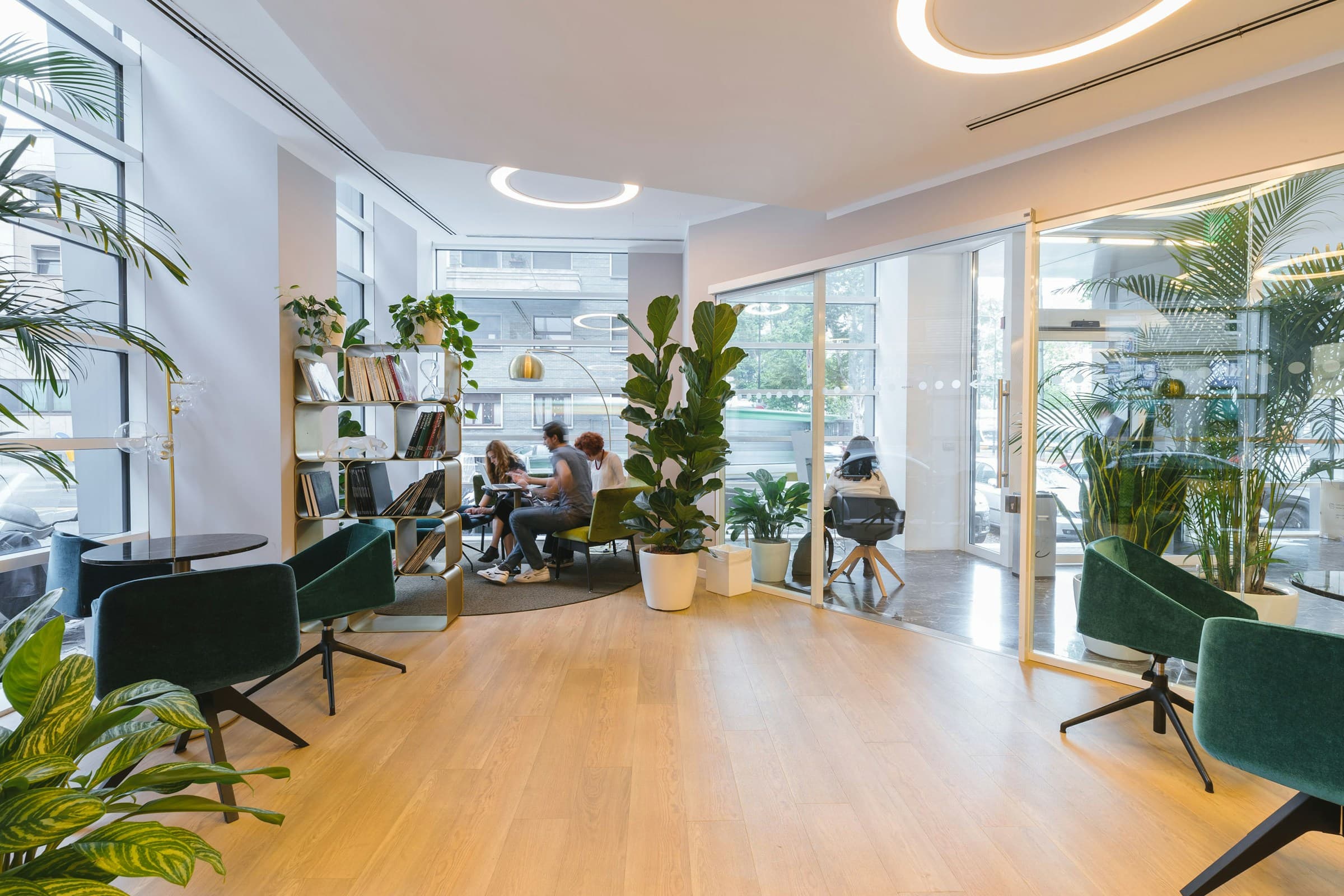 A contemporary commercial workplace with meeting areas and people working together.